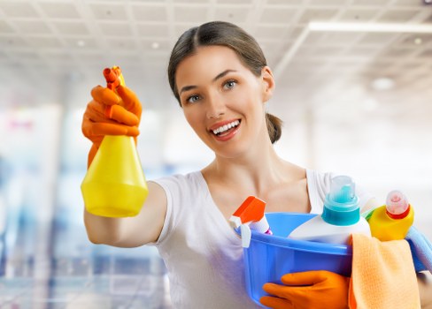 Cleaner using protective gloves during carpet stain removal